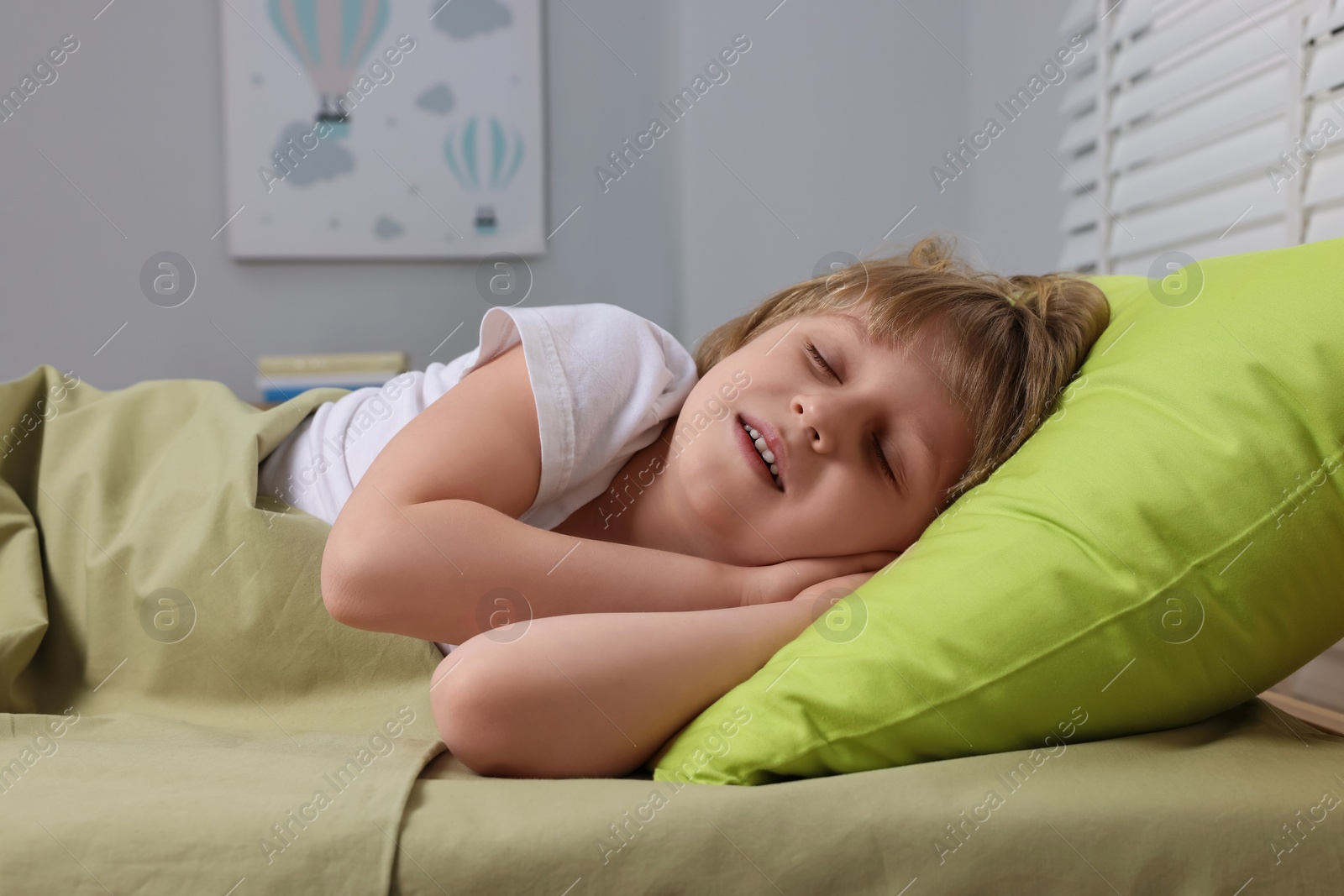 Photo of Little boy snoring while sleeping in bed at home