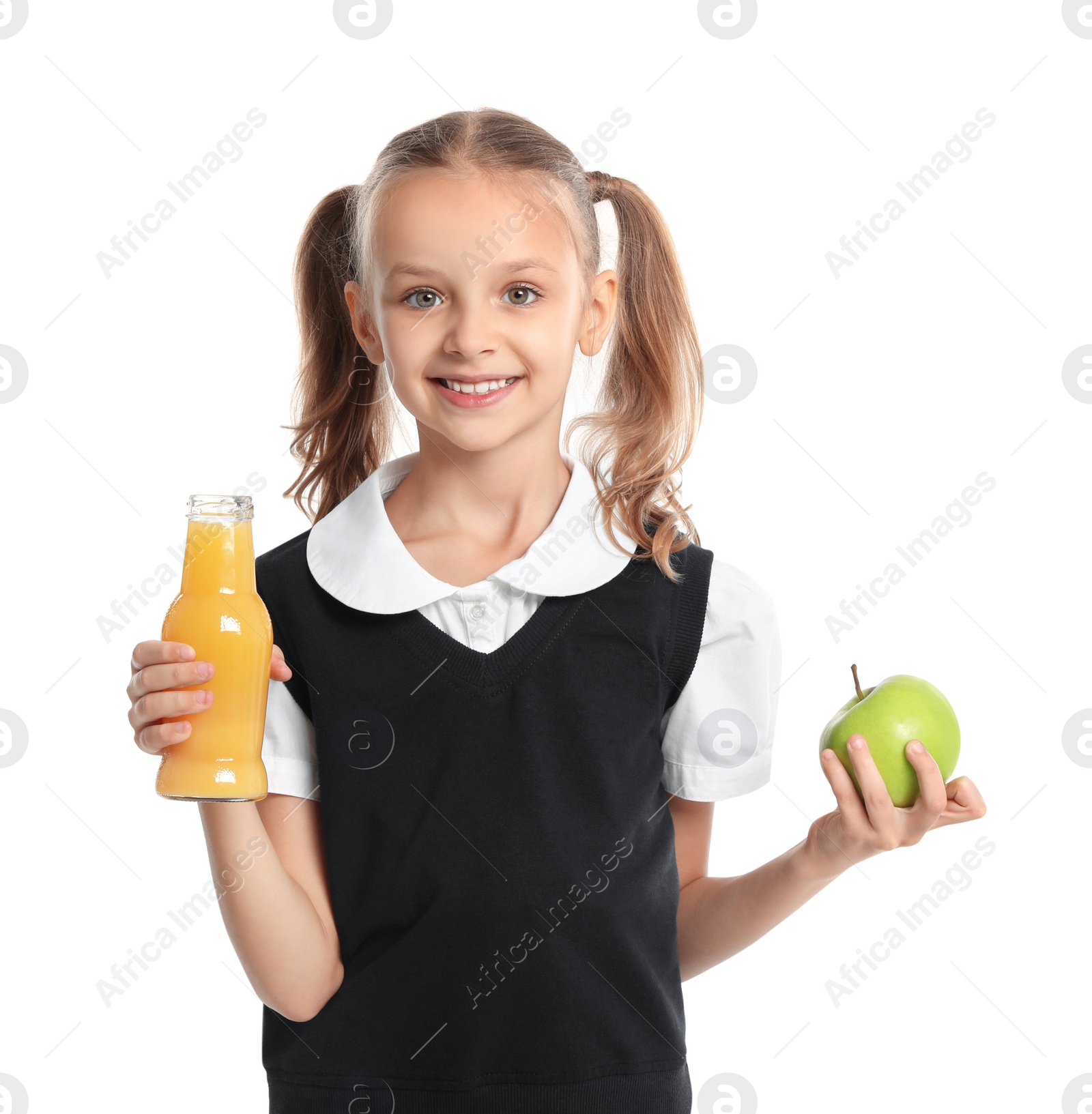 Photo of Happy girl holding apple and bottle of juice on white background. Healthy food for school lunch