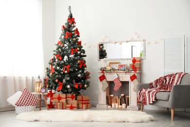 Stylish living room interior with decorated Christmas tree