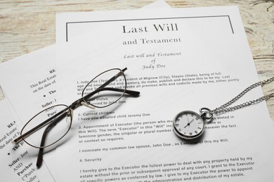 Photo of Last Will and Testament, glasses and pocket watch on white wooden table, above view