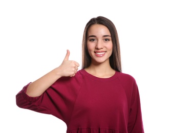 Woman showing THUMB UP gesture in sign language on white background