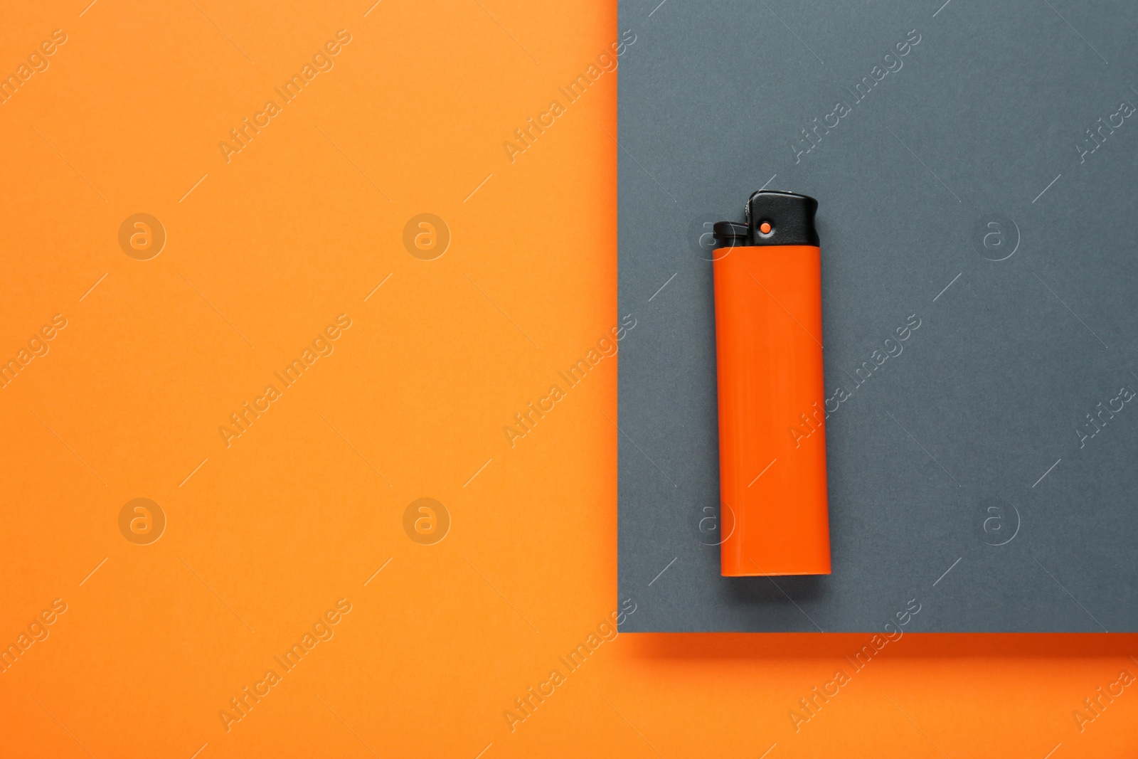 Photo of Stylish small pocket lighter on color background, top view. Space for text