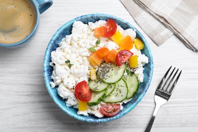 Photo of Delicious cottage cheese with vegetables and chia seeds served for breakfast on white wooden table, flat lay