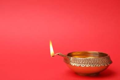Diwali diya or clay lamp on color background