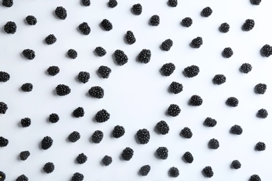 Frame made with fresh blackberries on white background, top view. Space for text