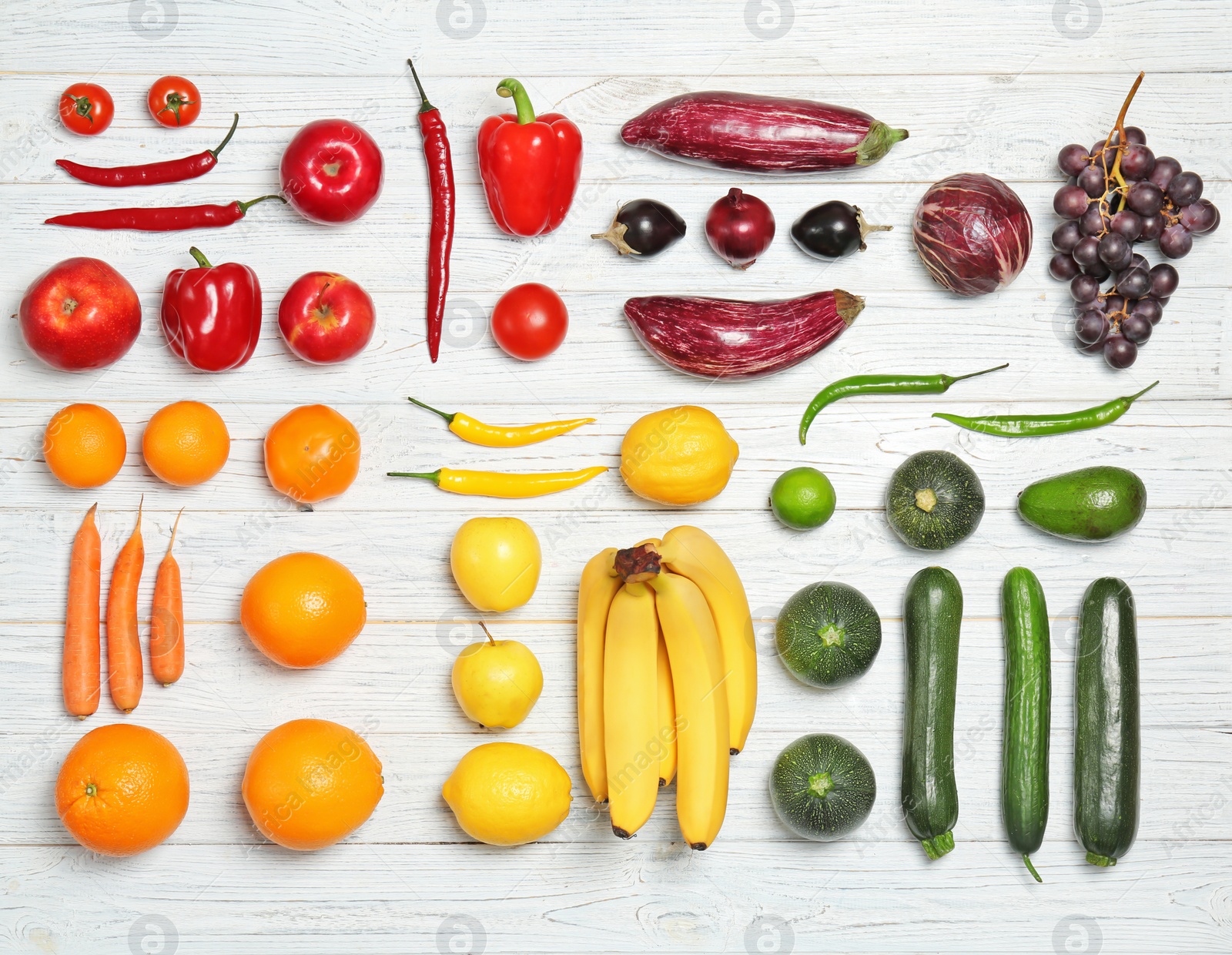 Photo of Rainbow composition with fresh vegetables and fruits on wooden background, flat lay