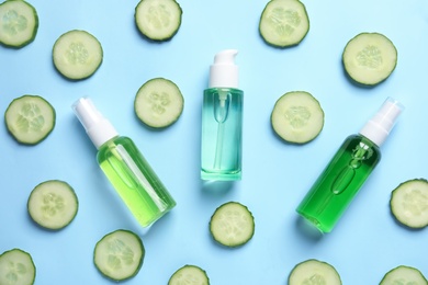 Photo of Flat lay composition with fresh cucumber slices cosmetic bottles on color background