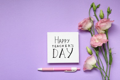 Photo of Paper with inscription HAPPY TEACHER'S DAY and flowers on violet background, flat lay. Space for text
