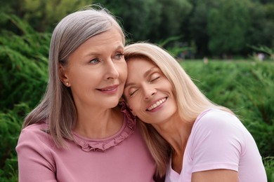 Photo of Happy mature mother and her daughter outdoors