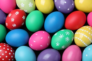 Photo of Colorful eggs as background, top view. Happy Easter