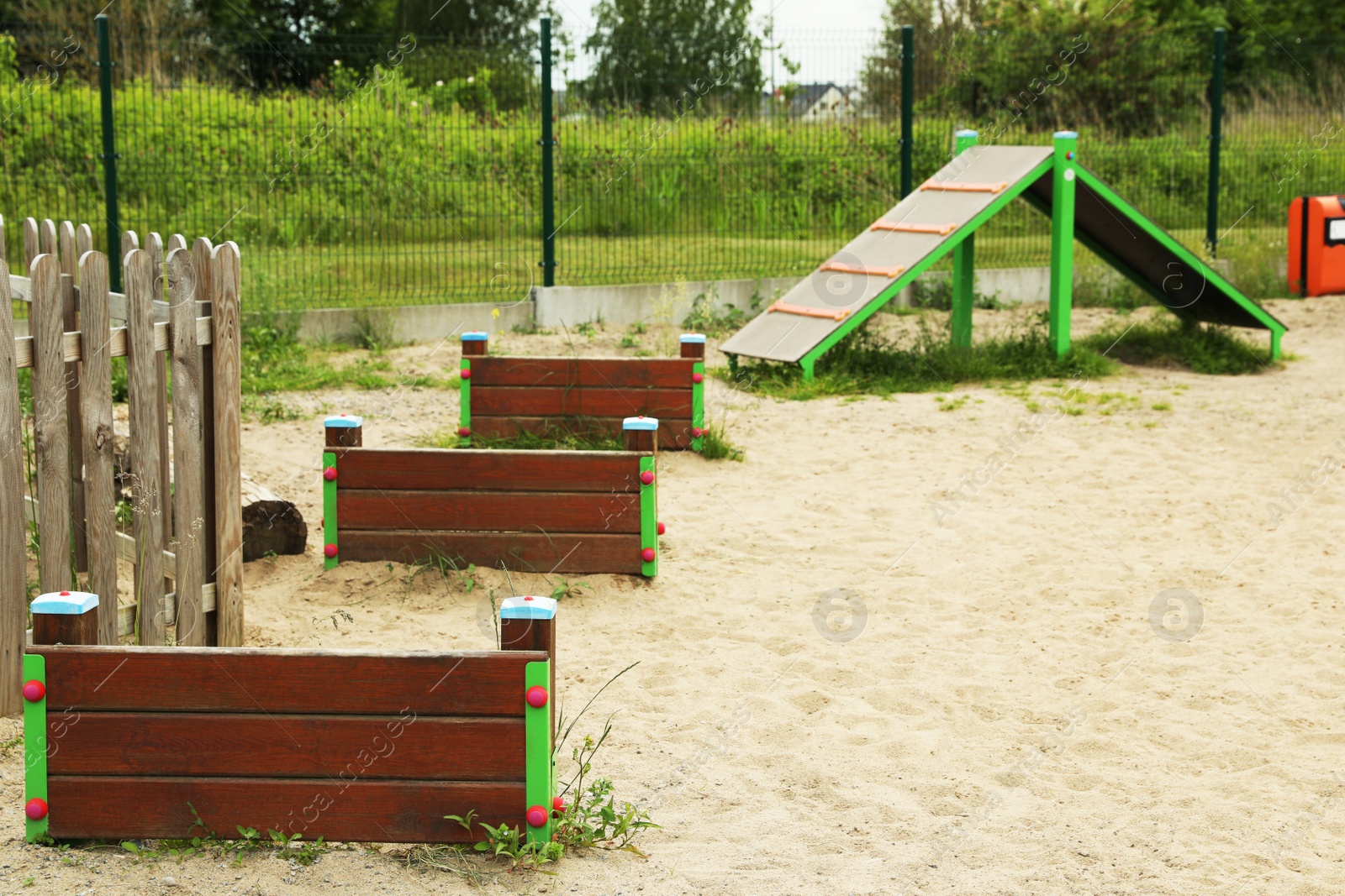 Photo of Wooden rover jump over and king of hill on animal training area outdoors