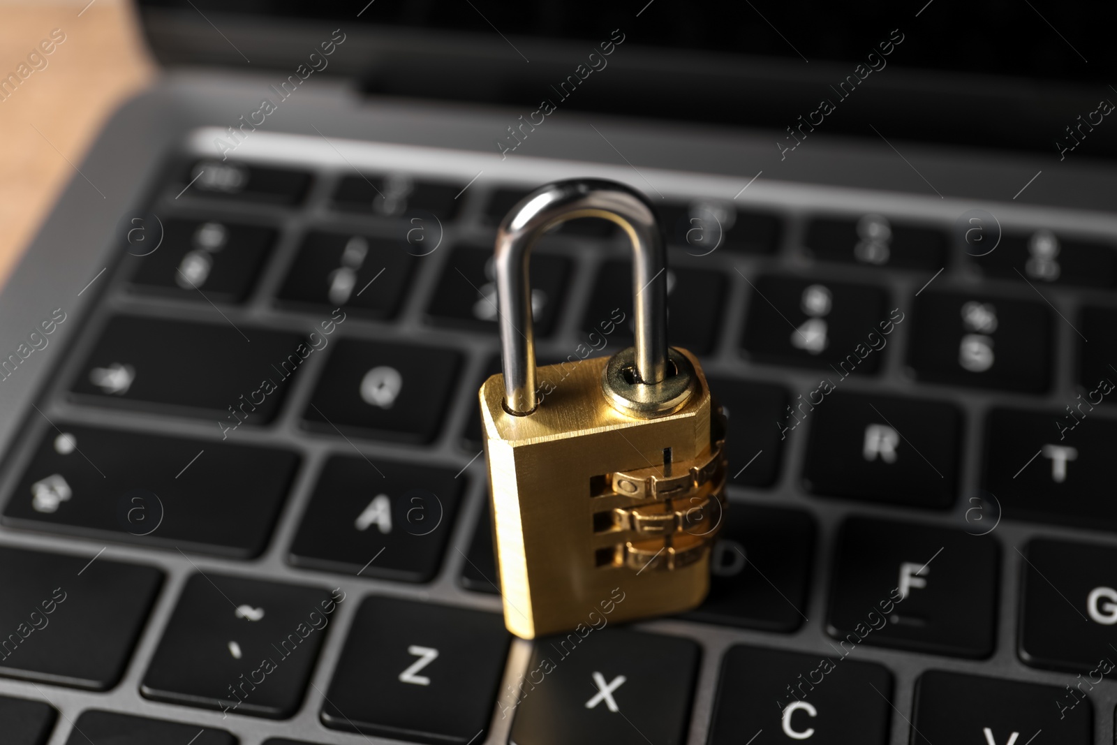 Photo of Cyber security. Laptop with padlock on table, closeup