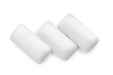 Photo of Three pieces of chewing gum on white background, top view