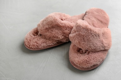 Pair of soft slippers on light grey background