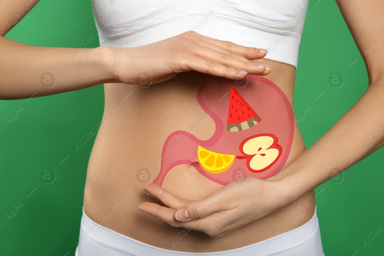 Image of Woman with image of stomach full of food drawn on her belly against green background, closeup. Healthy eating habits