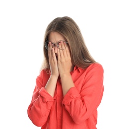 Young woman with glasses covering eyes on white background