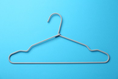 Hanger on light blue background, top view