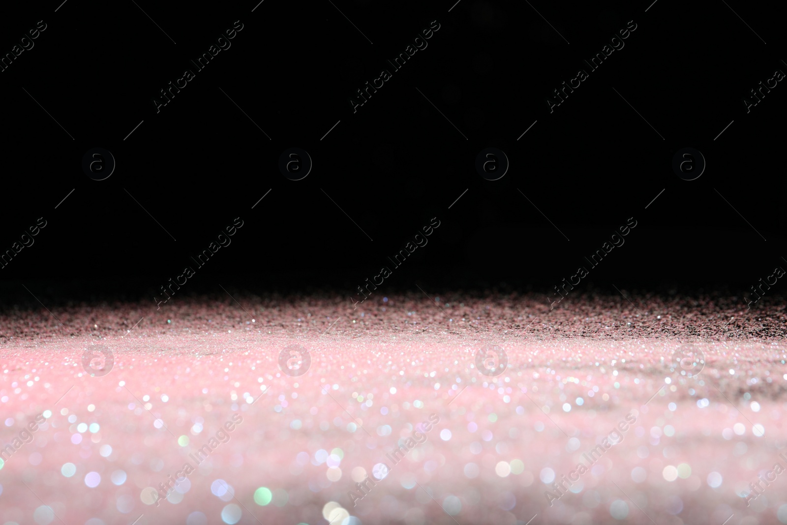 Photo of Shiny pink glitter on black background, space for text. Bokeh effect