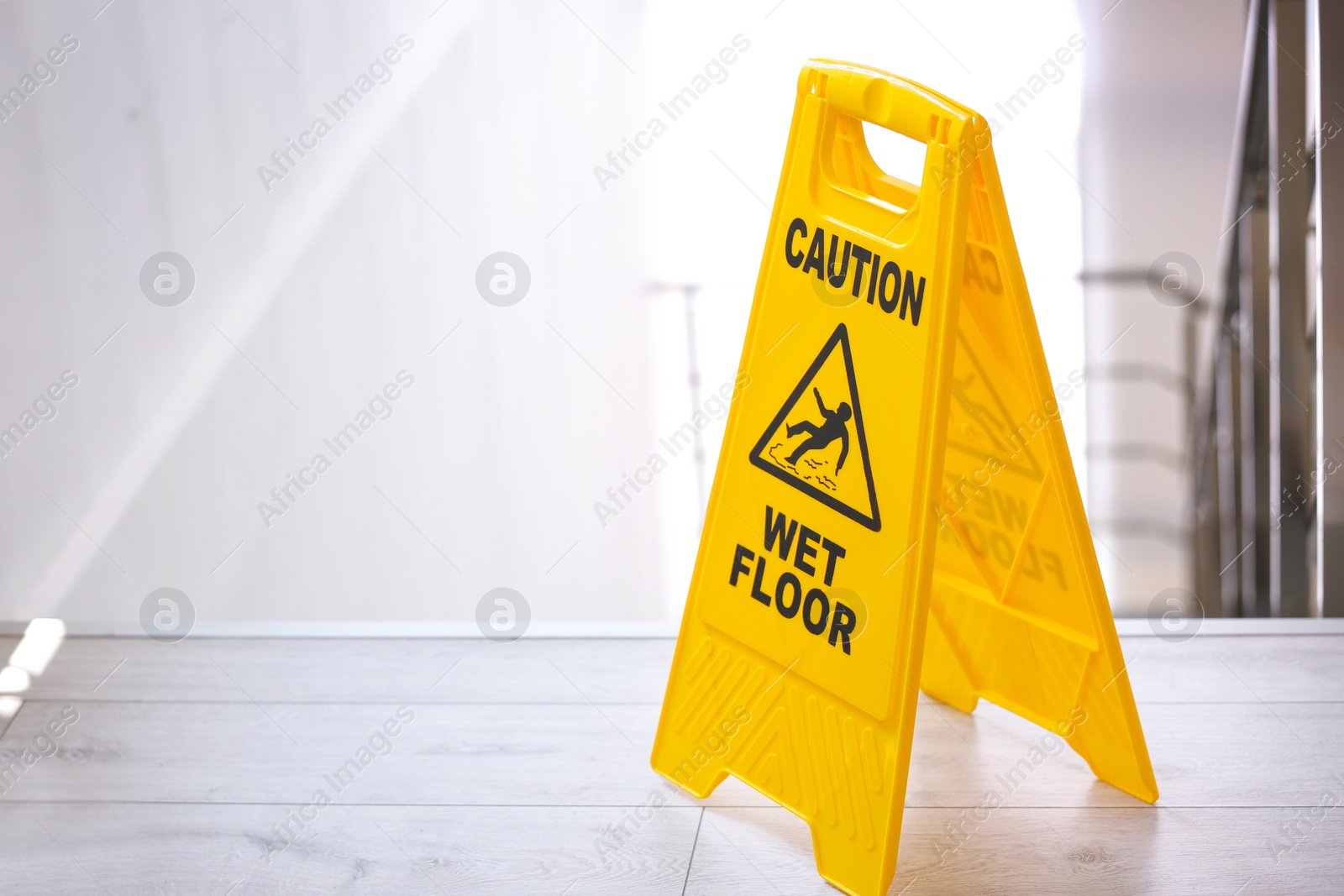 Photo of Safety sign with phrase Caution wet floor near stairs. Cleaning service