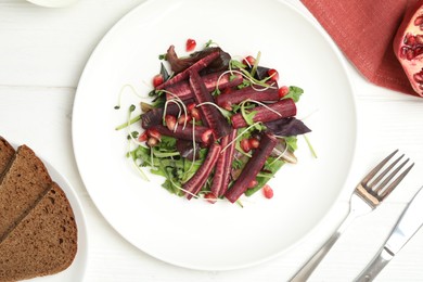 Photo of Delicious fresh carrot salad served on white wooden table, flat lay