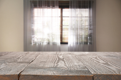 Image of Empty wooden table in room. Space for design