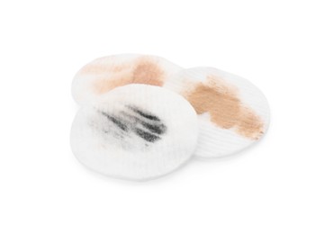 Photo of Dirty cotton pads after removing makeup on white background