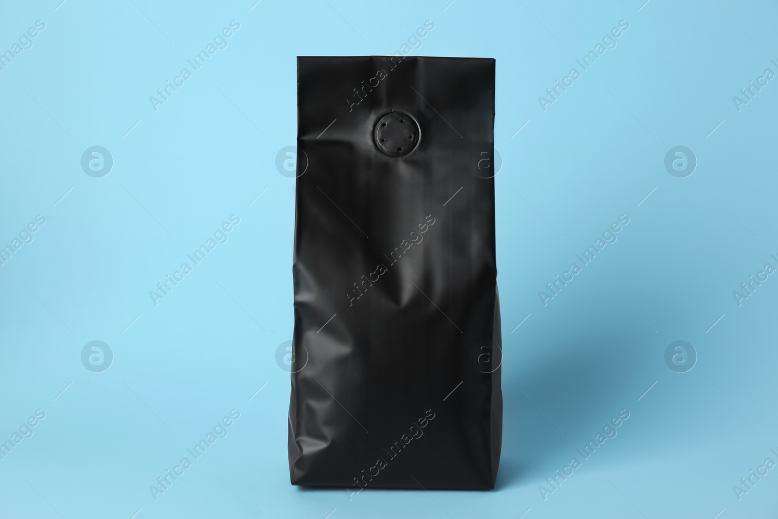 Photo of One blank foil package on light blue background