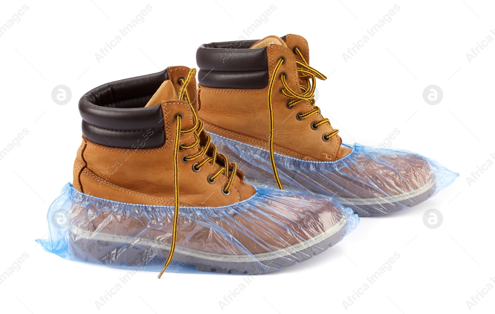 Photo of Boots in blue shoe covers isolated on white