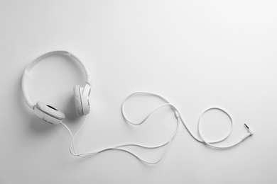 Photo of Stylish modern headphones with earmuffs on white background, top view. Space for text