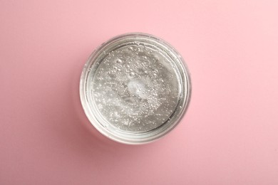 Photo of Jar of cosmetic gel on pink background, top view