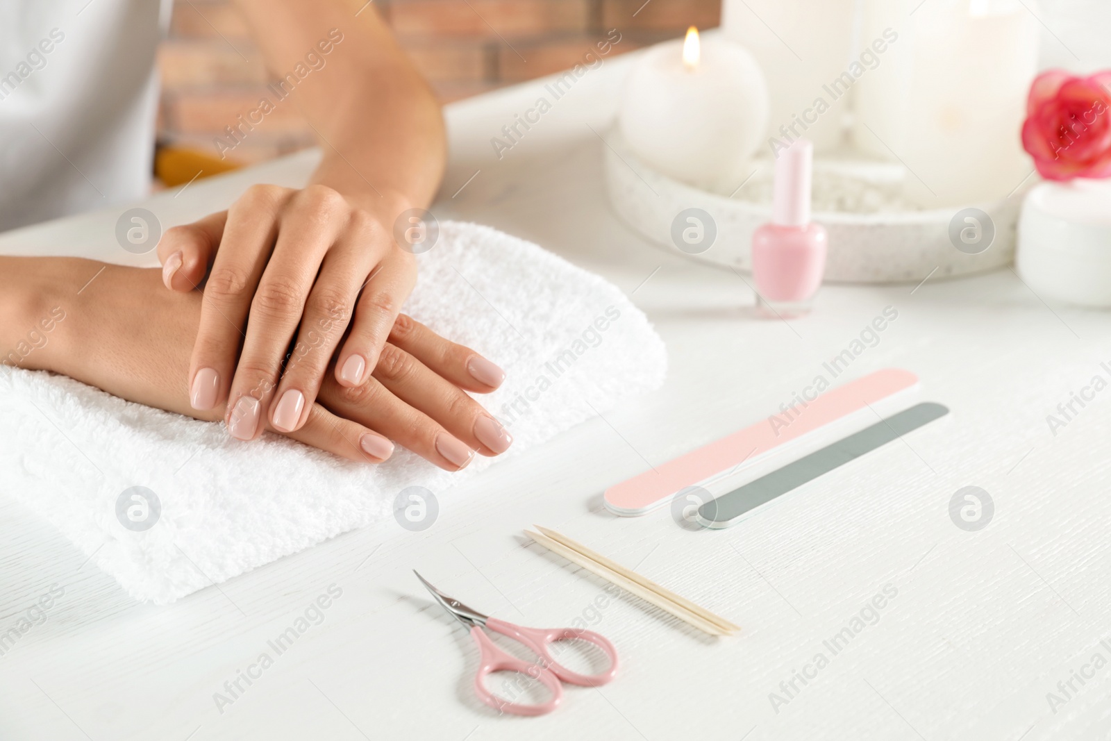 Photo of Woman waiting for manicure at table, closeup with space for text. Spa treatment