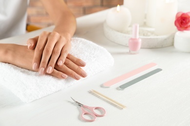 Woman waiting for manicure at table, closeup with space for text. Spa treatment