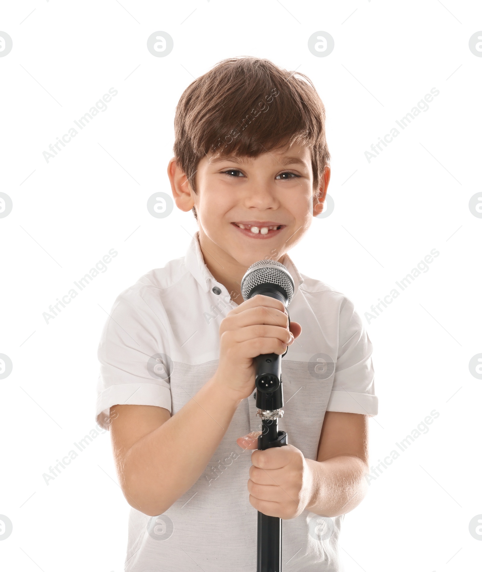 Photo of Cute little boy singing into microphone on white background