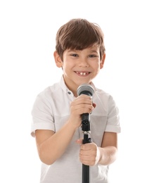 Cute little boy singing into microphone on white background