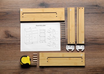 Photo of Flat lay composition with furniture parts and tools for self-assembly on wooden background