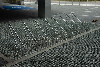 Photo of Empty metal parking rack for bicycles outdoors