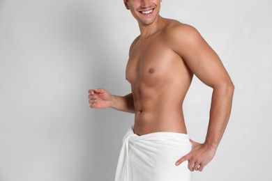 Photo of Man with sexy body on light background, closeup