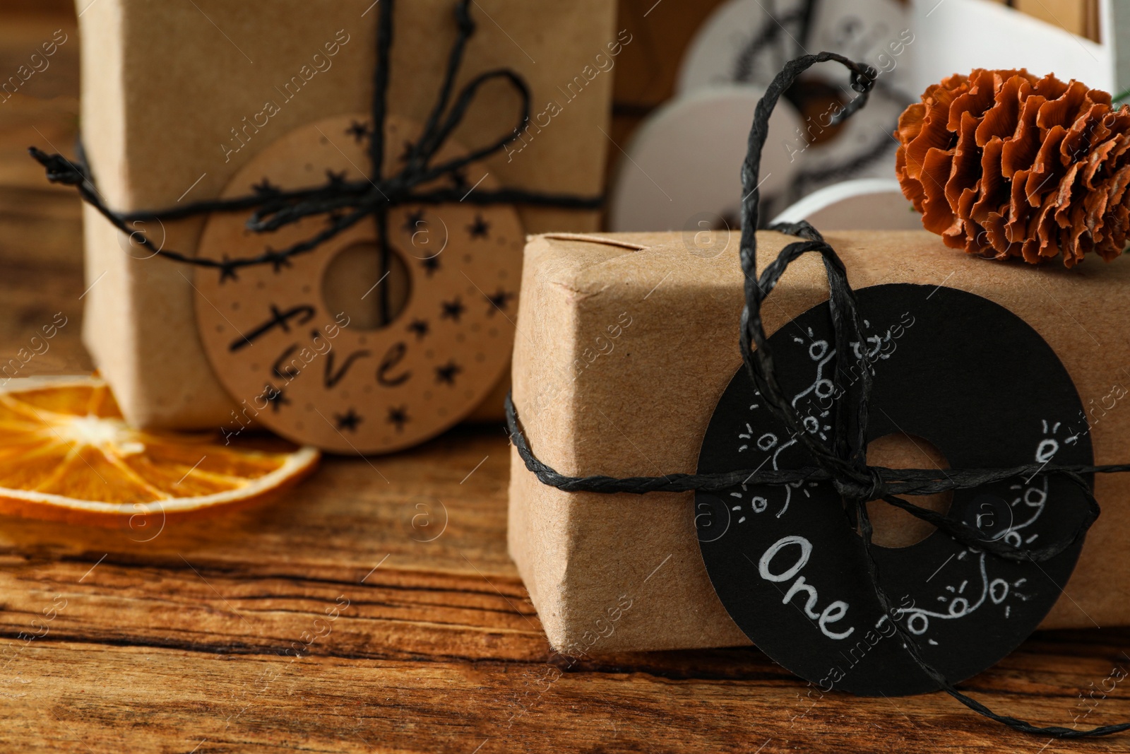 Photo of Gift for Christmas advent calendar on wooden table, closeup