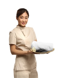 Photo of Professional masseuse in spa uniform holding tray with towel and rocks on white background