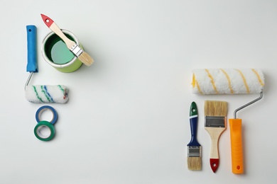 Photo of Set of decorator's tools on light background, flat lay