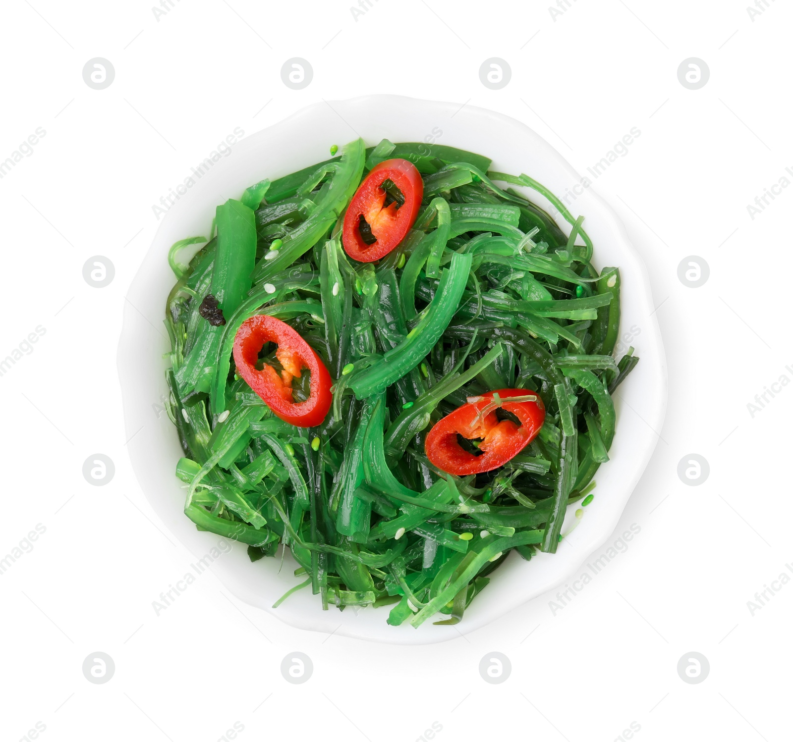 Photo of Tasty seaweed salad in bowl isolated on white, top view