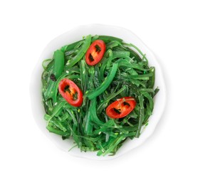 Photo of Tasty seaweed salad in bowl isolated on white, top view