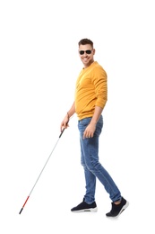 Photo of Blind man in dark glasses with walking cane on white background