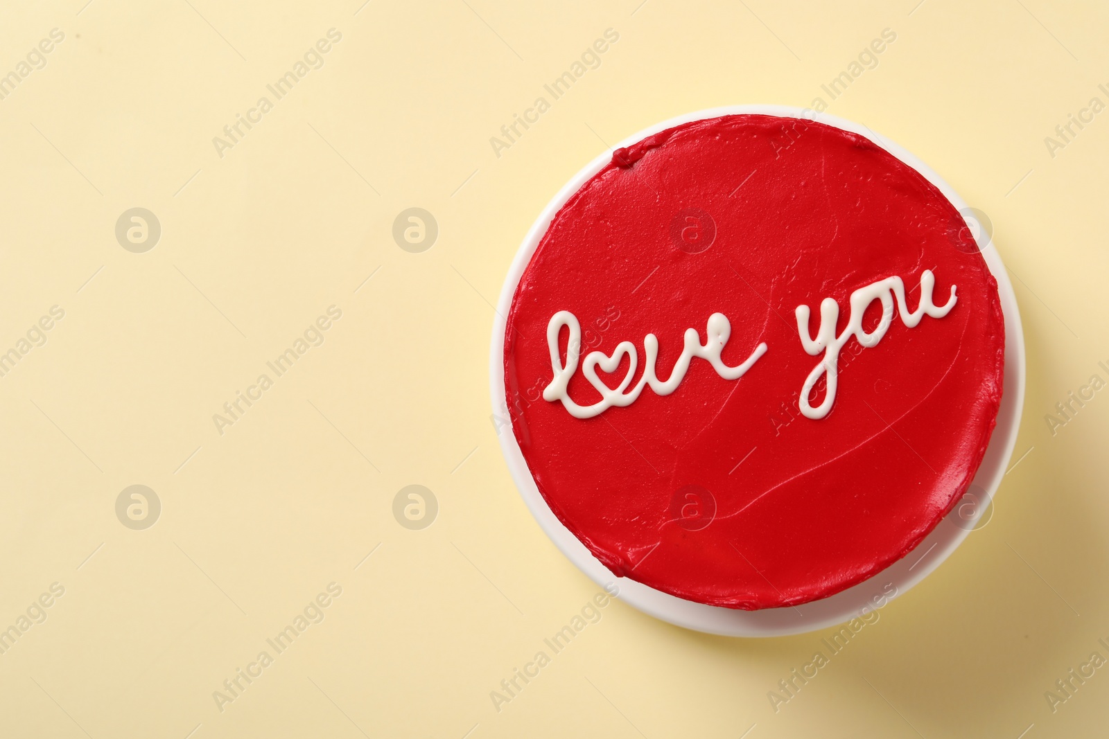 Photo of Bento cake with text Love You and space for text on beige table, top view. St. Valentine's day surprise