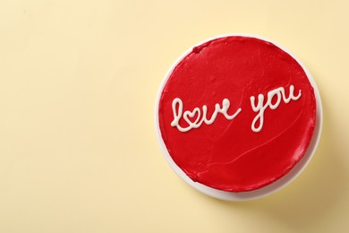 Photo of Bento cake with text Love You and space for text on beige table, top view. St. Valentine's day surprise