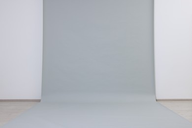 Modern light grey photo background. Professional studio equipment