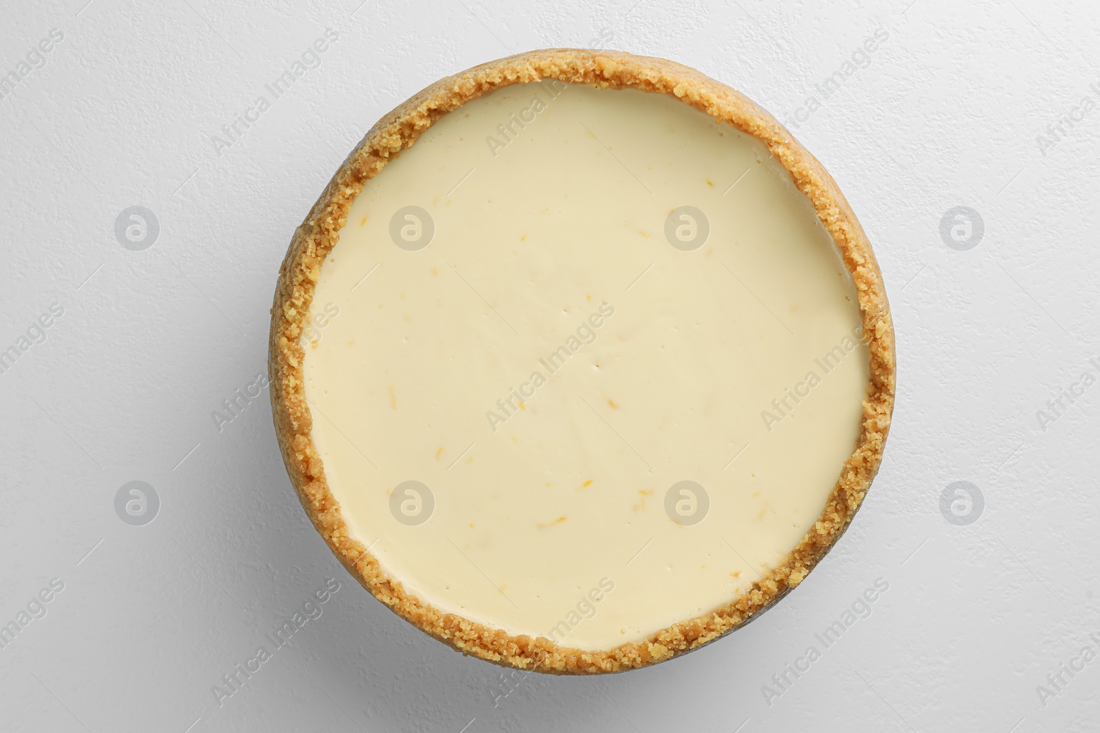 Photo of Tasty vegan tofu cheesecake on white table, top view