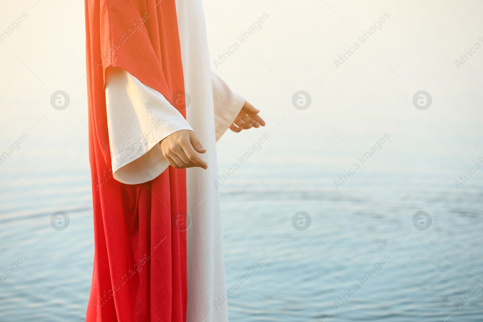 Photo of Jesus Christ near water outdoors, closeup. Space for text