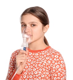 Photo of Cute girl using nebulizer for inhalation on white background