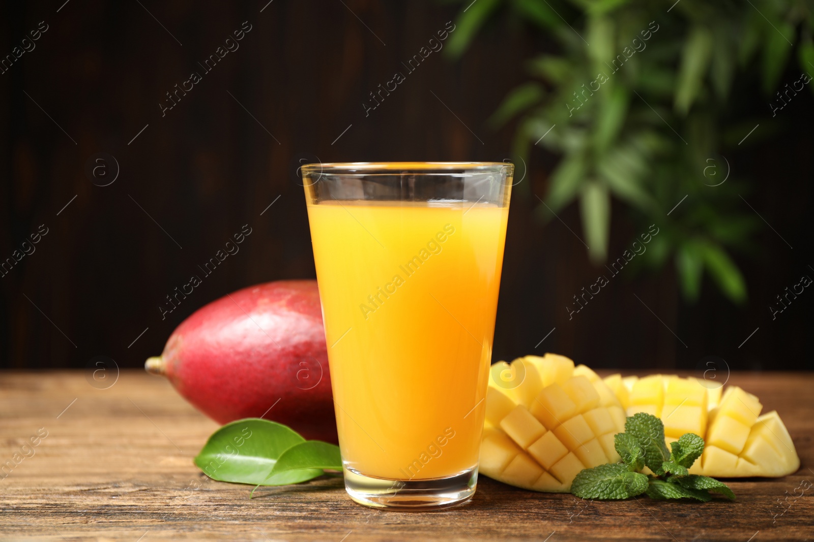 Photo of Fresh delicious mango drink on wooden table